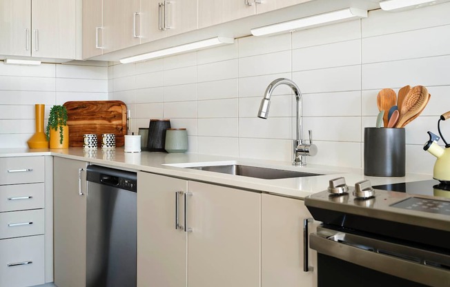 a kitchen with white cabinets and a sink