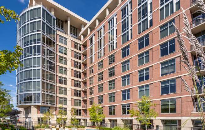 A large building with a pool in front of it.