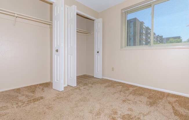 Standard unit master bedroom with carpeting and double closets  at 444 Park Apartments, Ohio, 44143
