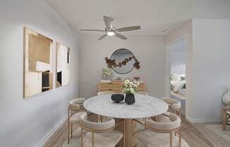 A dining room with a round table and chairs.