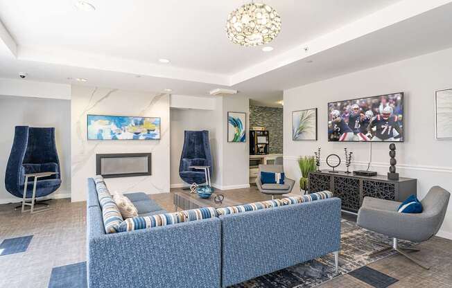 Parkside Commons community room with fire place and a blue sofa and a fireplace.