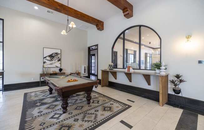 a game room with a pool table and a bar