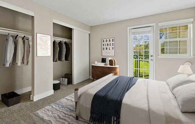 A bedroom with a bed, a dresser, and a window with a view of trees.