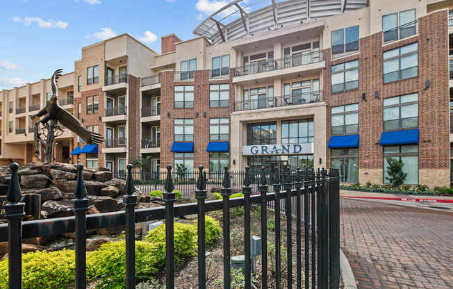 a large building with a statue and a fence in front of it