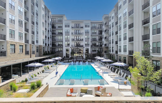 Heated knife-edge saltwater pool with sun shelves, cabanas, deck shower and water feature