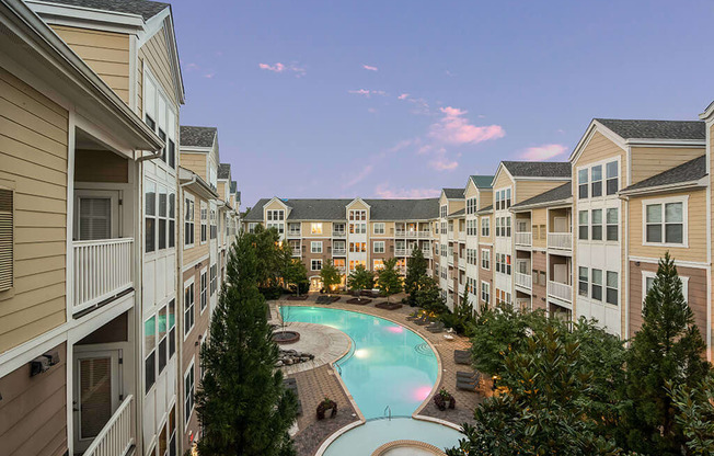 an apartment building with a large swimming pool