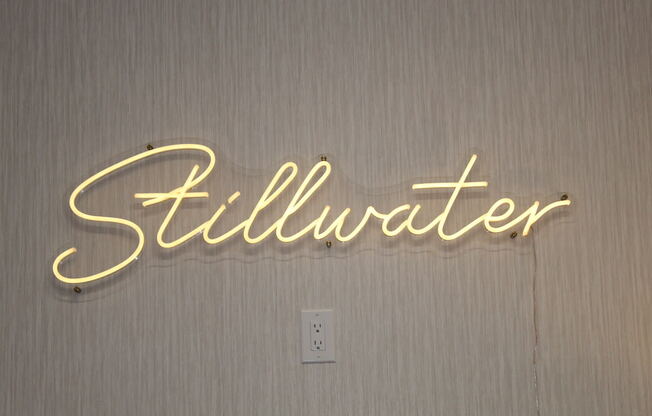 a neon sign that reads Stillwater in clubhouse at Stillwater at Grandview Cove