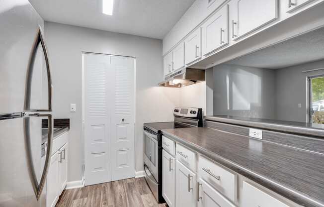 Galley Kitchen With White Cabinetry & Brushed Nickel Hardware