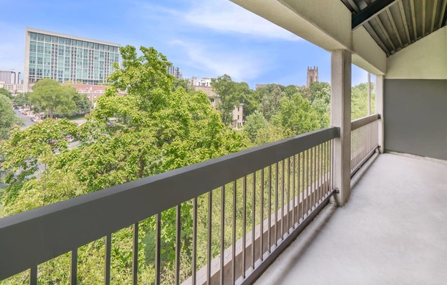 a balcony with a view of the city and trees