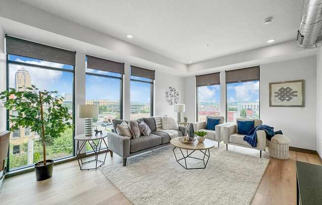 a living room with large windows and a rug