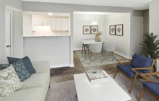 a living room with a couch a table and chairs and a kitchen in the background at Planters Trace, Charleston South Carolina