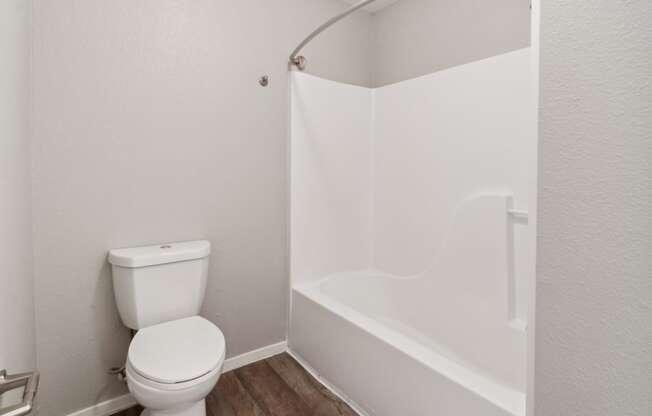 an empty bathroom with a toilet and a shower