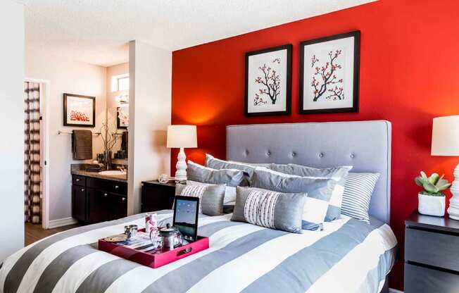 bedroom with breakfast tray on bed and bathroom in background