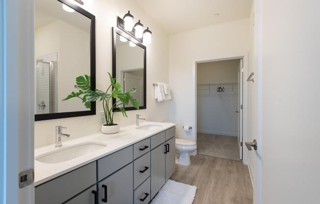 a bathroom with two sinks and a toilet