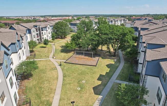 an aerial view of a neighborhood with houses and a park