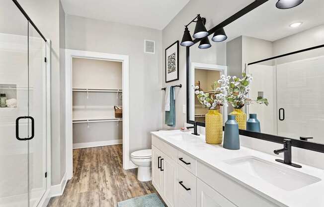 A bathroom with a white sink and a mirror.
