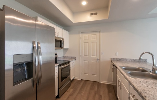 This is a photo of the kitchen of the 1500 square foot 3 bedroom, 2 and a half bath with 2-car garage Bellbrook floor plan at Washington Park Apartments in Centerville, OH.