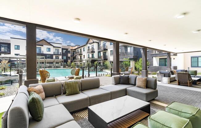 Outdoor lounge areas with comfortable seating and poolside views provide an inviting space to gather, relax, or work outdoors.