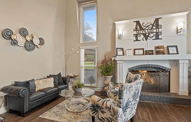 a living room with couches and chairs and a fireplace