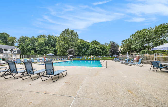 A resort-style pool surrounded by chairs at Apple Ridge Apartments, Michigan, 49534