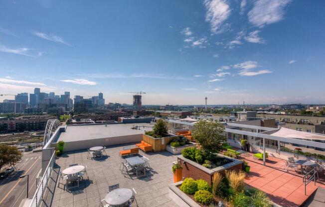 a roof terrace with a view of the city