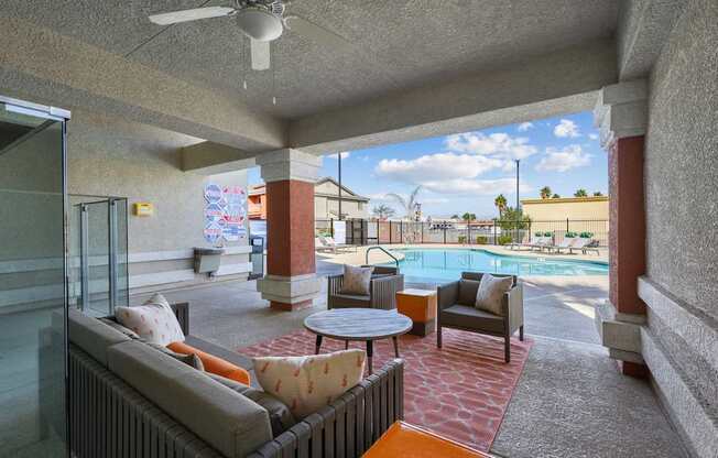 A patio with a pool table and chairs.