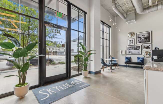 the lobby of a building with glass doors and a view of the street