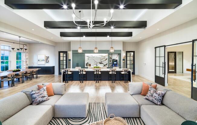 Bold beams, designer lighting, and curated textures set the tone for refined community spaces at Modera South Shore in Marshfield, MA.