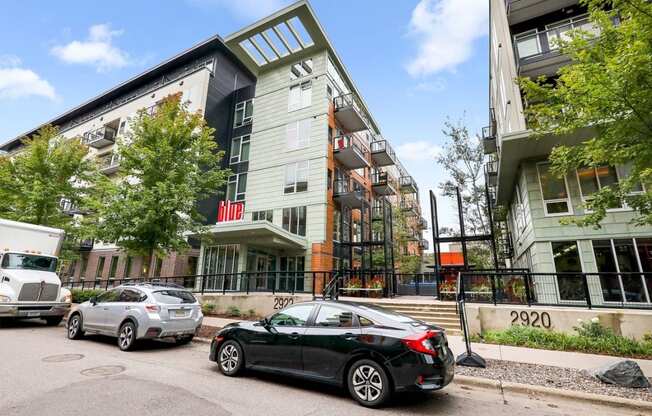 an apartment building with cars parked in front of it