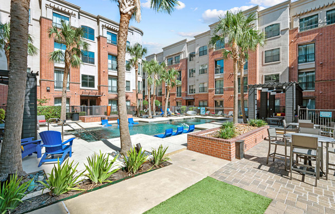 our apartments offer a pool and lounge area with palm trees