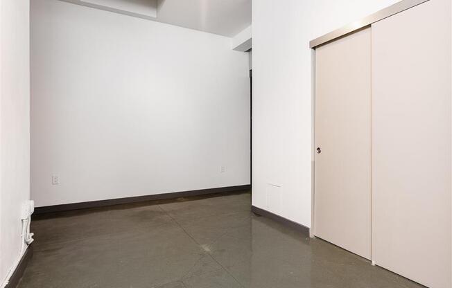 a room with white walls and a concrete floor