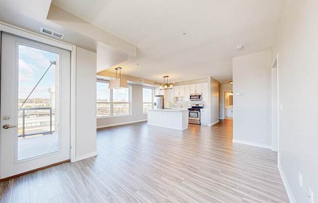 A spacious living room with a view of the city through the large windows.