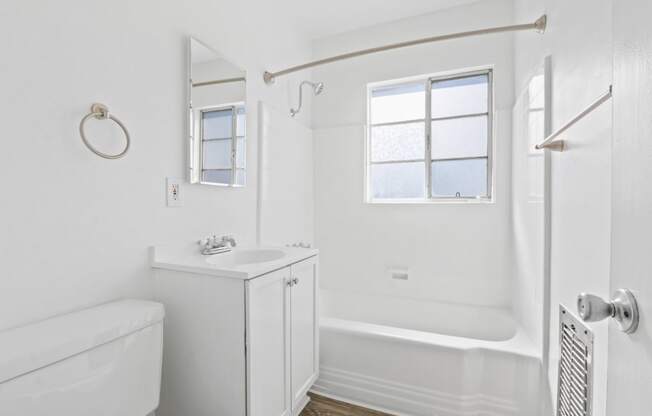 a bathroom with a sink and a shower and a tub