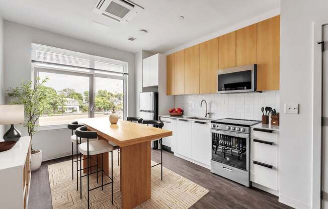 A modern kitchen with white appliances and wooden cabinets.