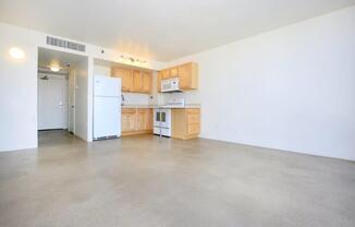A kitchen with white appliances and wooden cabinets.