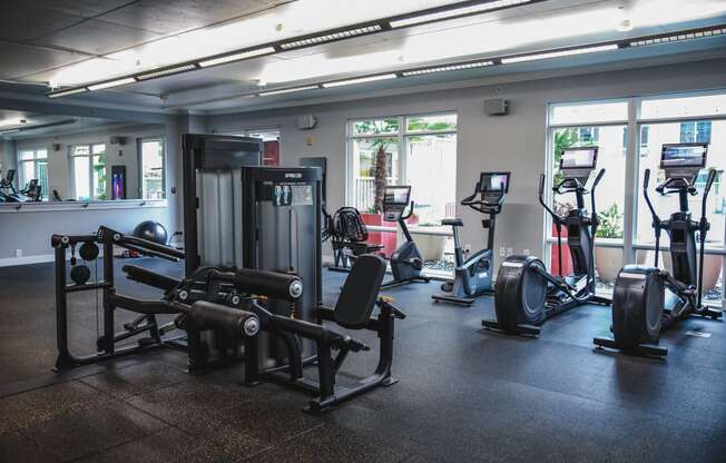 a gym with cardio equipment and weights in a building