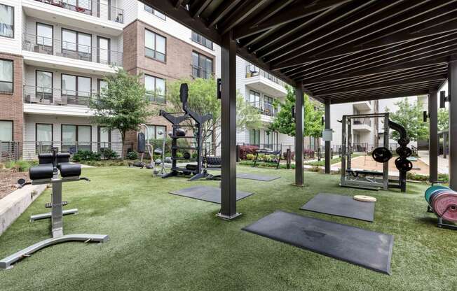 amenities including a fitness center with weights and cardio equipment on the grass