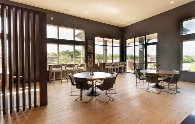 a large dining room with tables and chairs and windows