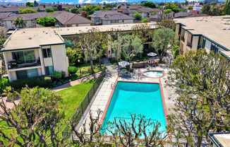 a backyard with a swimming pool and a house at Casa Del Amo Apartments, Torrance, CA 90505