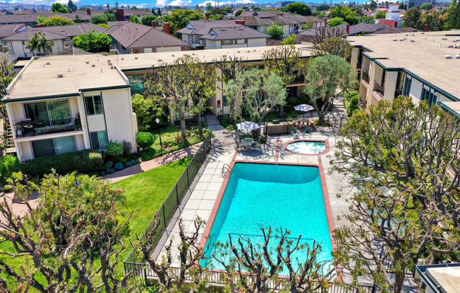 a backyard with a swimming pool and a house at Casa Del Amo Apartments, Torrance, CA 90505