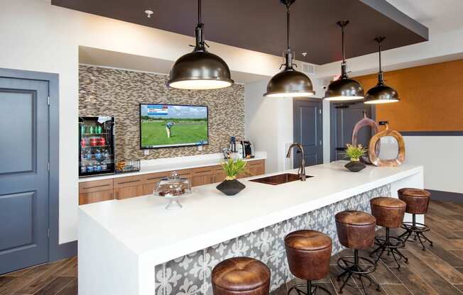 a kitchen with a long counter and stools