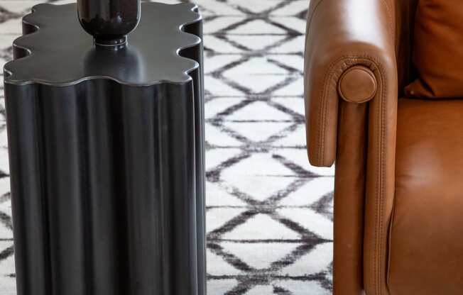 a side table with a black finish and a potted plant on top of it