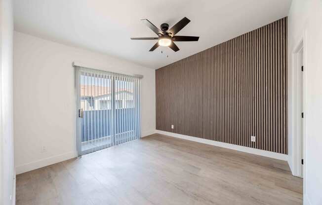 the living room has a sliding glass door to the patio