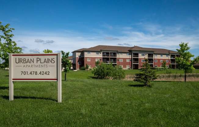 an urban plans sign in front of an apartment building