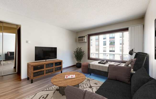 a living room with a large window and a couch