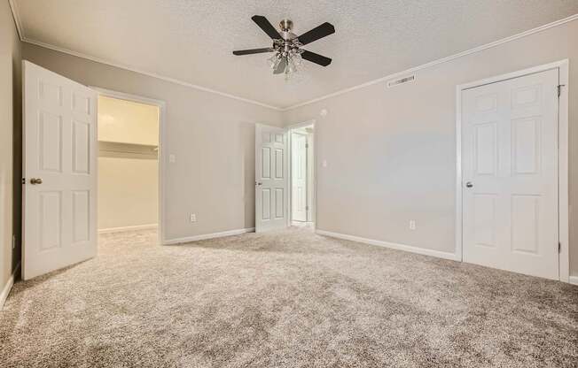 Bedroom with spacious closet and ceiling fan