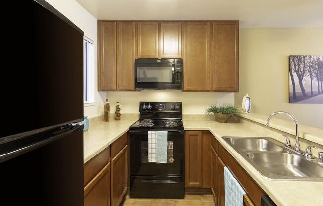 California Place Kitchen with Black Appliances