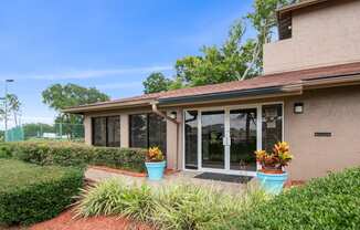 the view of the front of a house with potted plants in front of it