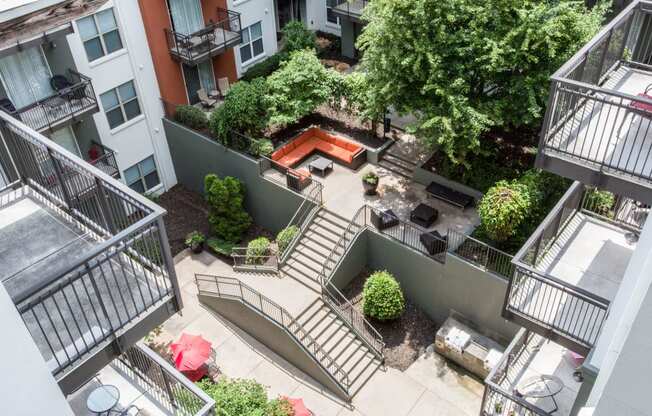 an aerial view of an apartment complex with stairs and a pool