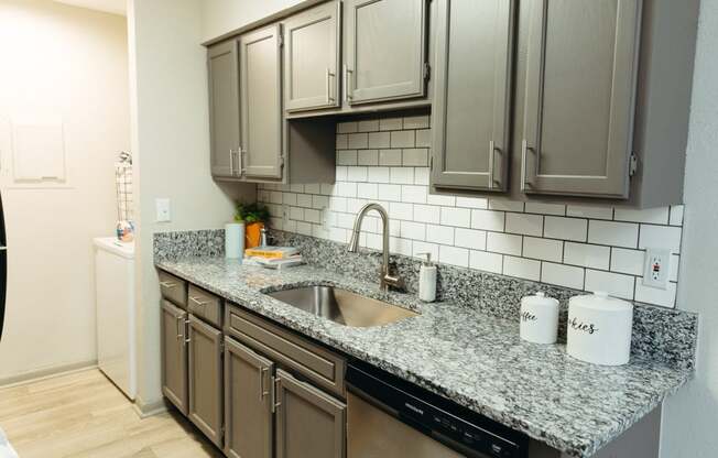 a kitchen with granite counter top and stainless steel appliances